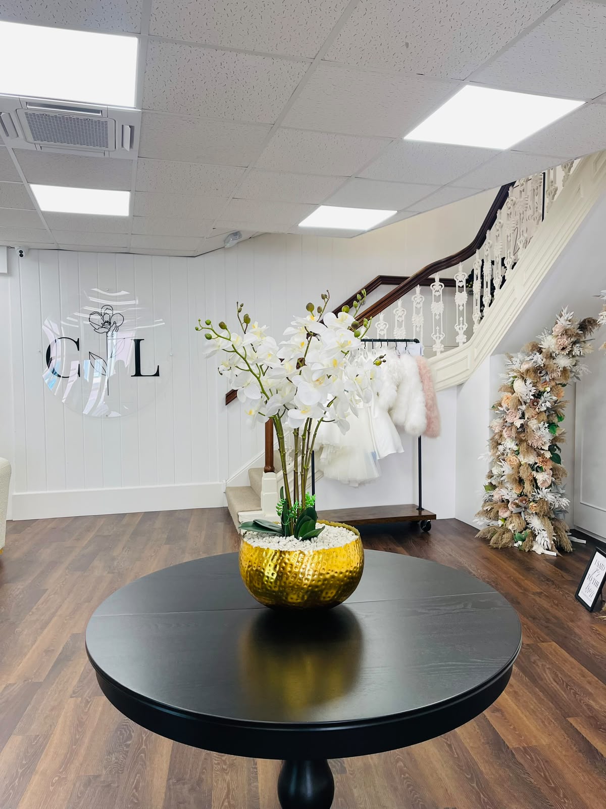 Leaf artificial orchids at Champagne & Lace bridal boutique, Louth – white orchids in gold hammered bowl champagne and lace boutique